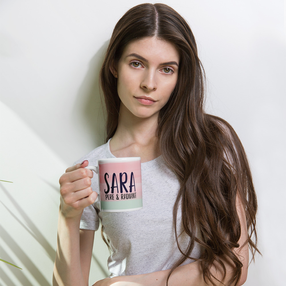 Woman holding pink and mint personalized SARA coffee mug