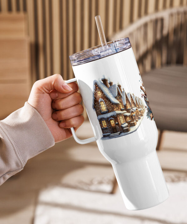 Hand holding Gingerbread Village travel mug