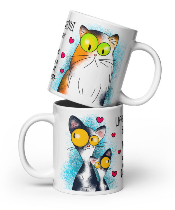 White ceramic mug with two colorful cats and “Life is short hug your meow” text