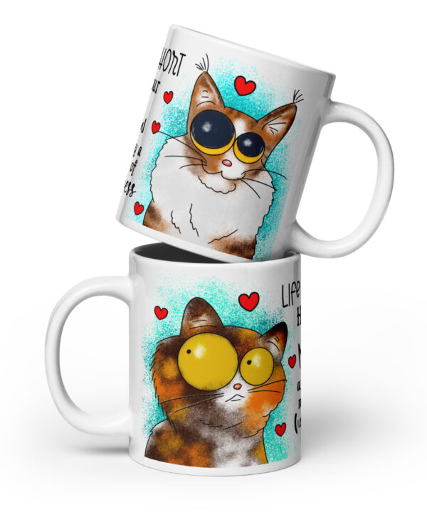 White ceramic mug with two cats, turquoise background, hearts, and the quote “Life is short hug your meow.