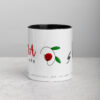 White coffee mug with red flower design and inspirational text.