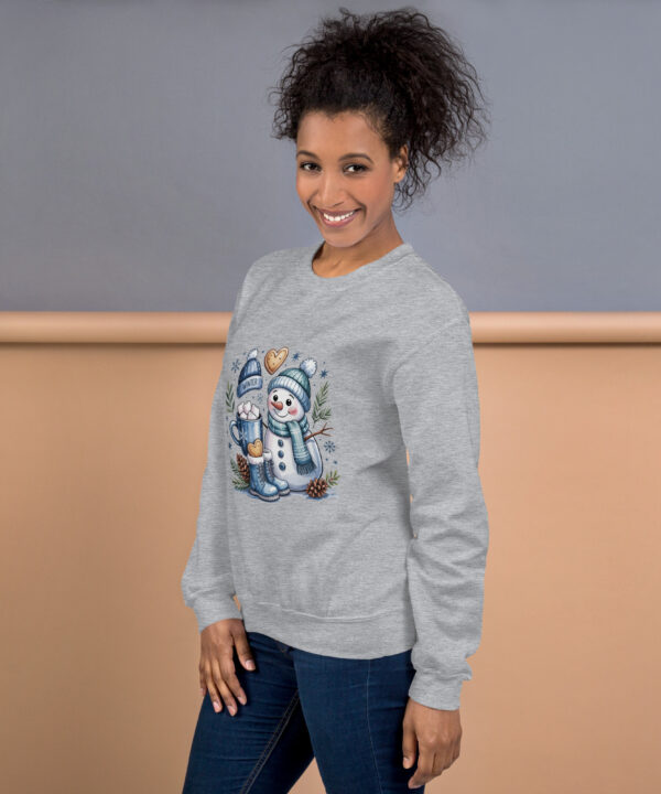 Woman smiling in cozy gray sweatshirt with snowman graphic.