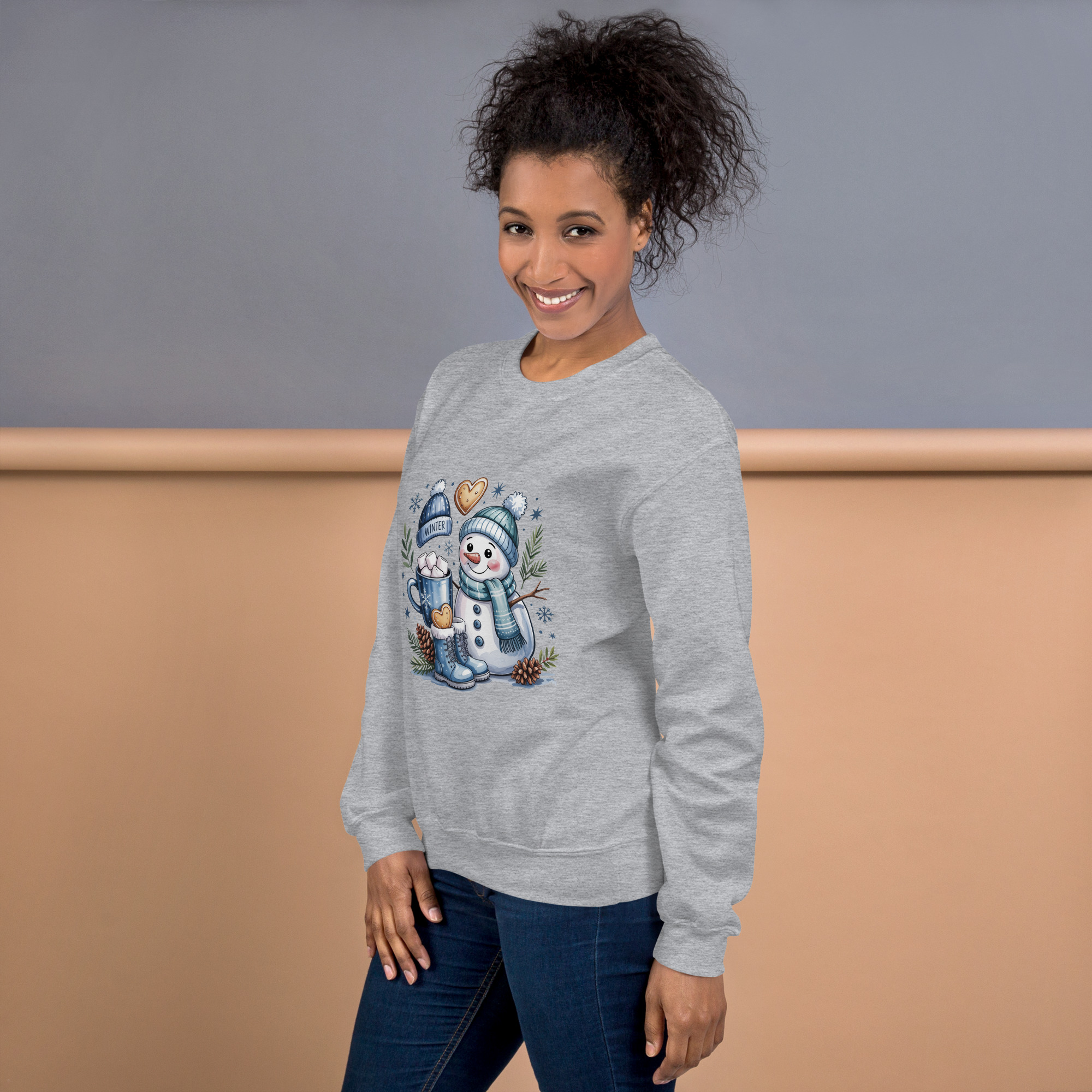 Woman smiling in cozy gray sweatshirt with snowman graphic.