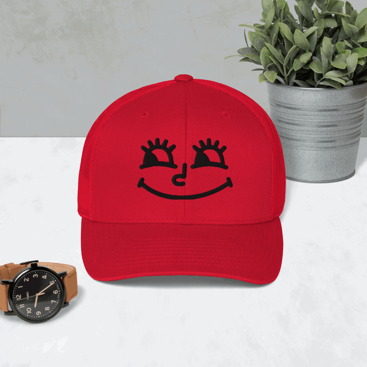 Bright red baseball cap with a cute smiling face graphic, perfect for casual wear.