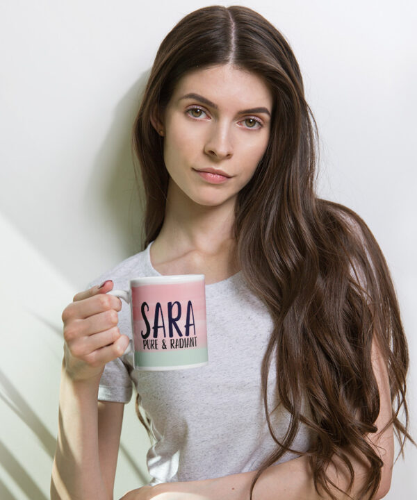 Woman holding pink and mint personalized SARA coffee mug