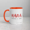 Red Hana Peace & Joy coffee mug with orange interior.