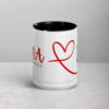 White ceramic coffee mug featuring a bold red NA heart design.