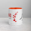 White Noor mug with orange interior, red hearts, and black text.