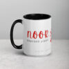 Black and white mug featuring noor in vibrant red script.