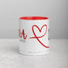 White Rana heart coffee mug with red interior on gray surface.