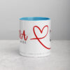 White Rana coffee mug with red heart design and blue interior.