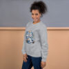 Woman smiling in cozy gray sweatshirt with snowman graphic.